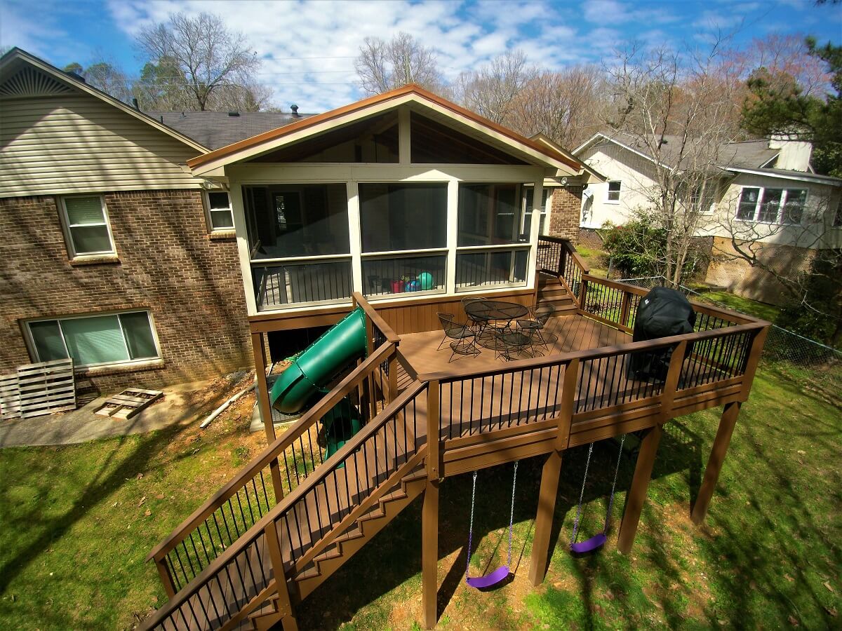 wood deck with tube slide and swings